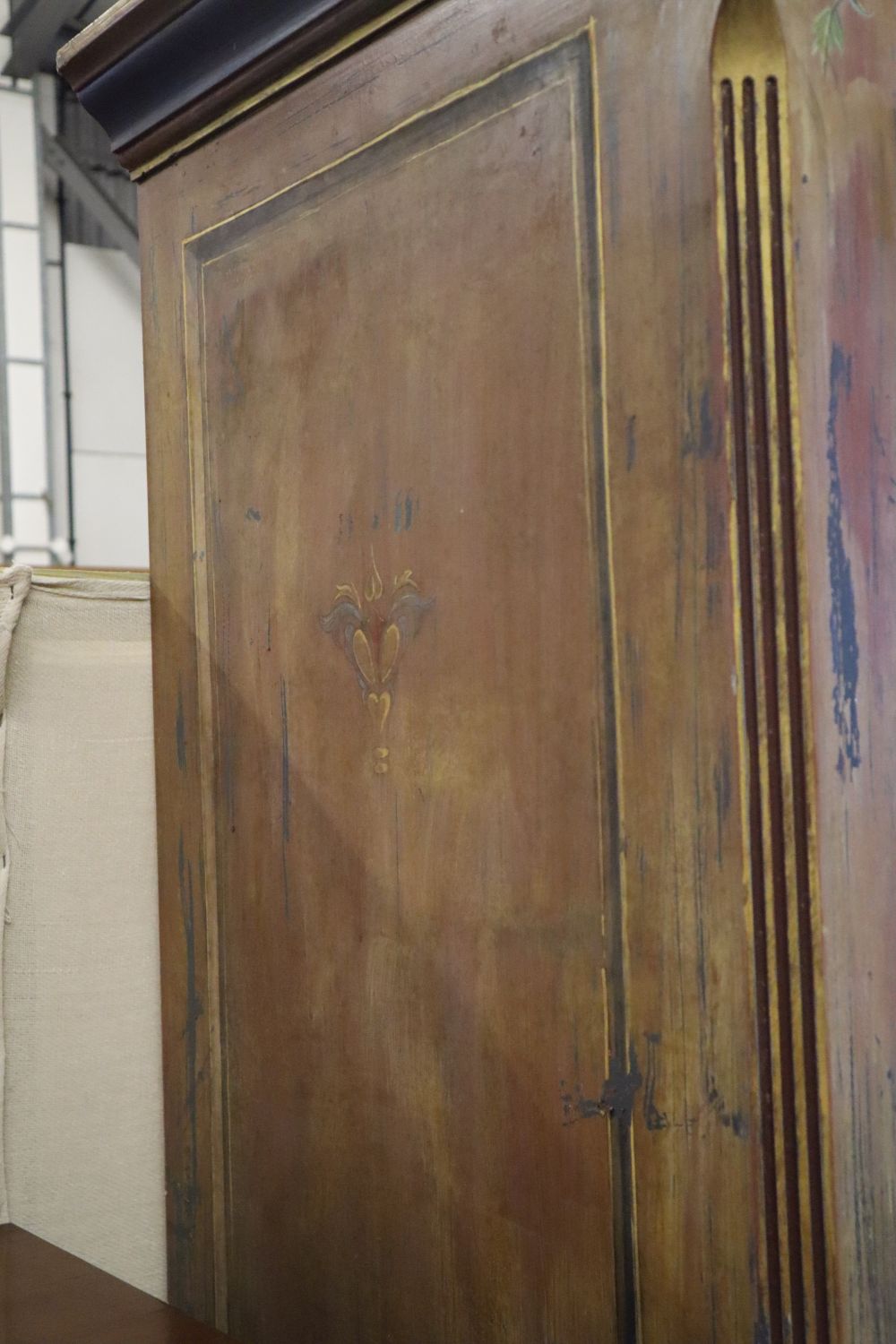 A 19th century Continental painted armoire, later decorated with birds on branches, rabbits and fish, the top two doors each enclosing